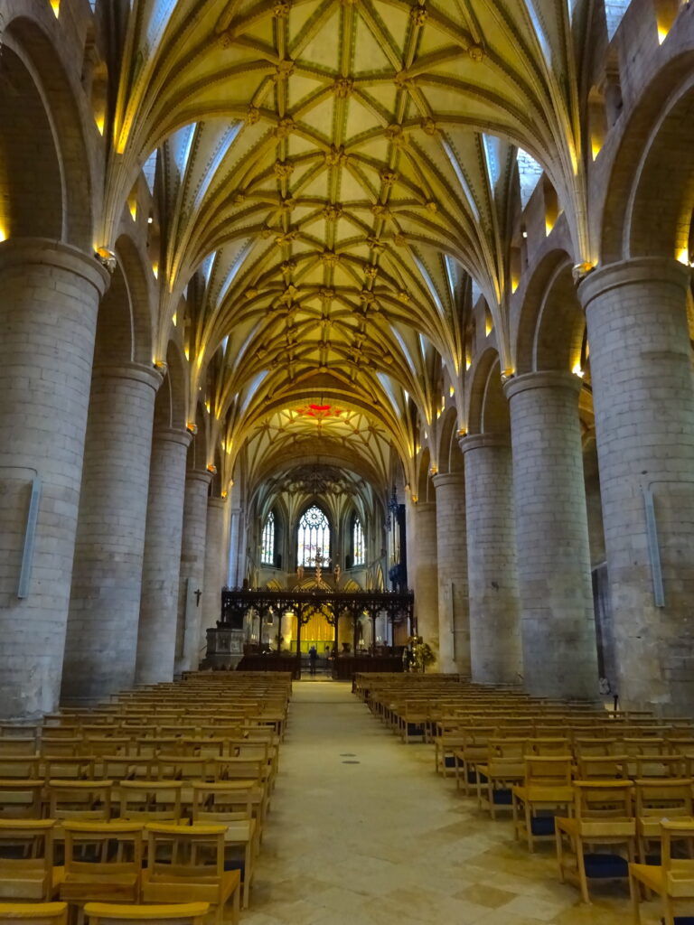 Inside The Abbey Looking Towards A Stained Glass Window